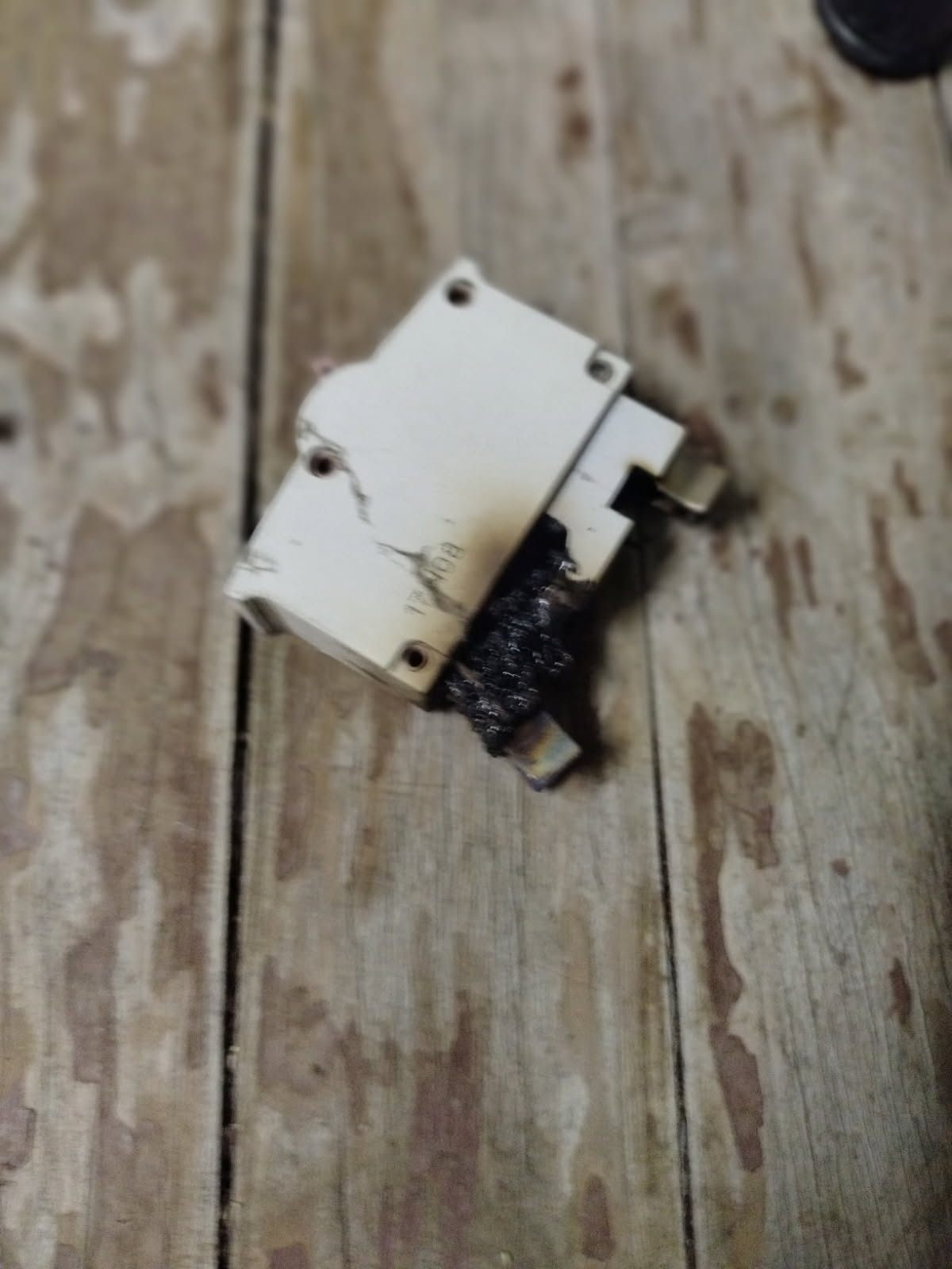 Burnt circuit breaker removed after a burning smell at a home switchboard