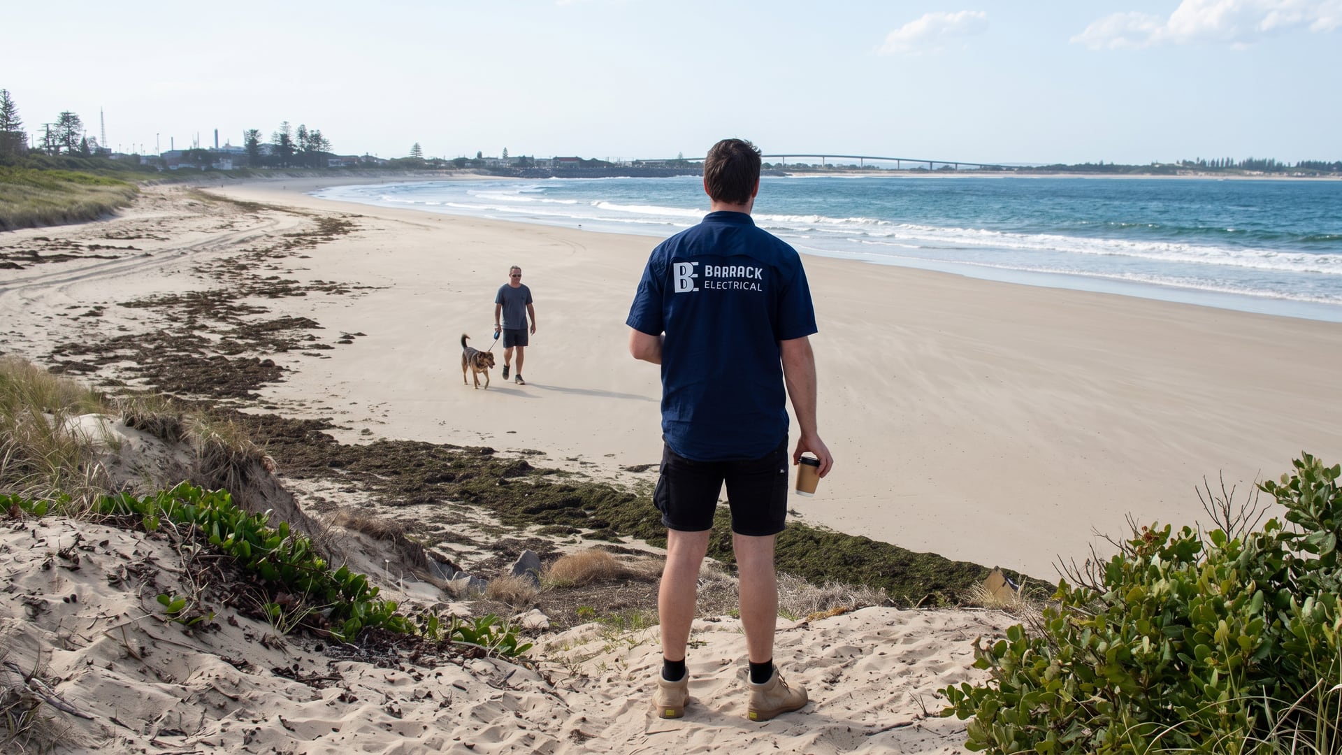 A Barrack Electrical electrician looking out over the southern end of Stockton Beach behind Fern Bay