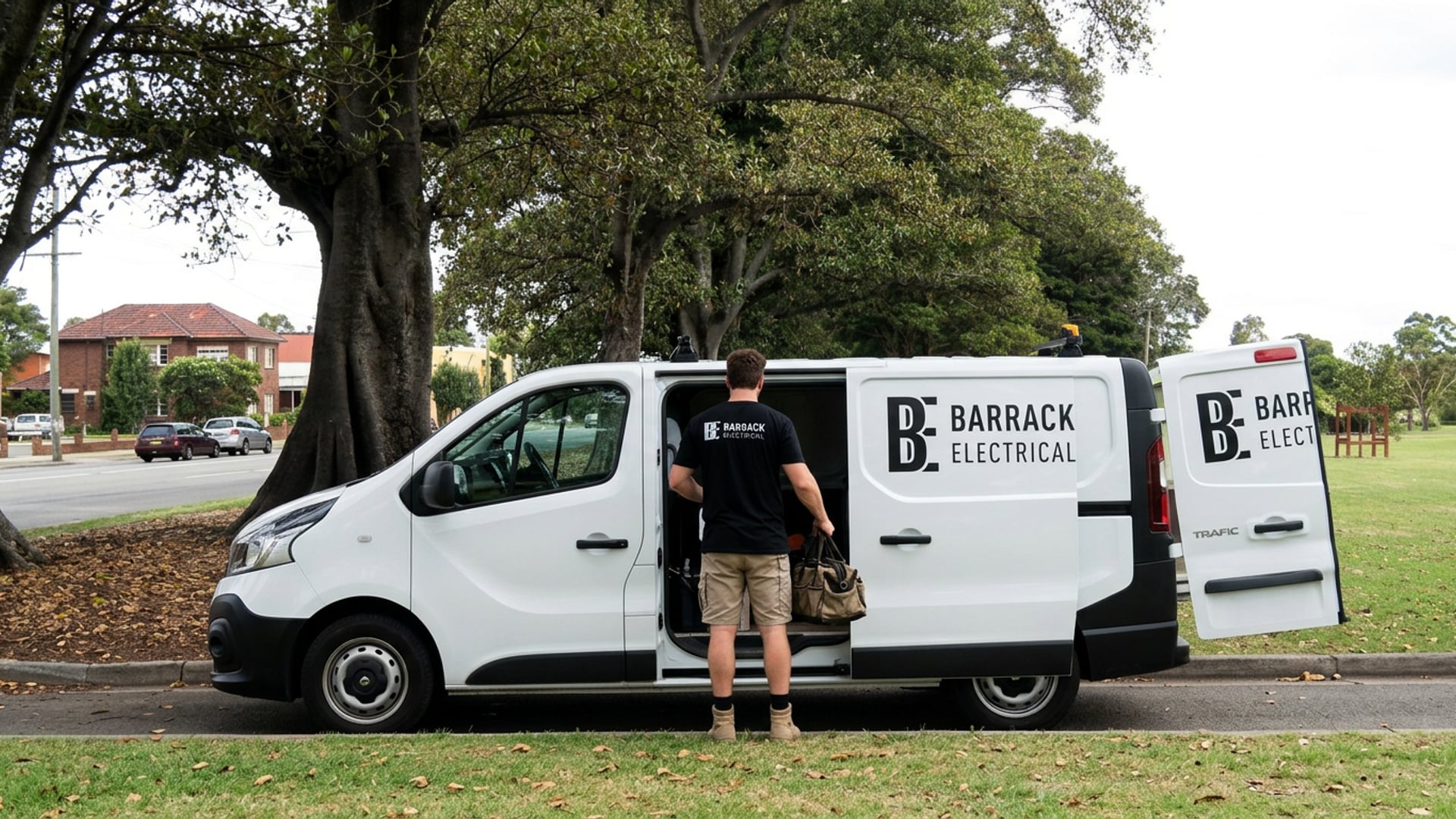 A Barrack Electrical van parked under the fig trees at Islington Park