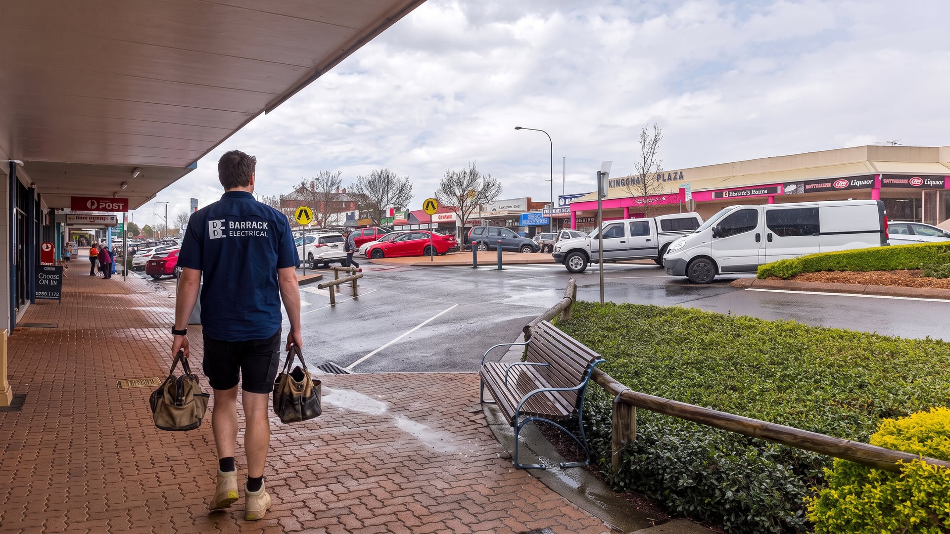 A Barrack Electrical electrician walking along Lang Street, Kurri Kurri with his tool bags