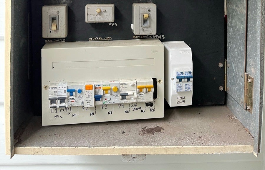 A switchboard rebuilt with safety switches, each circuit written up beneath it
