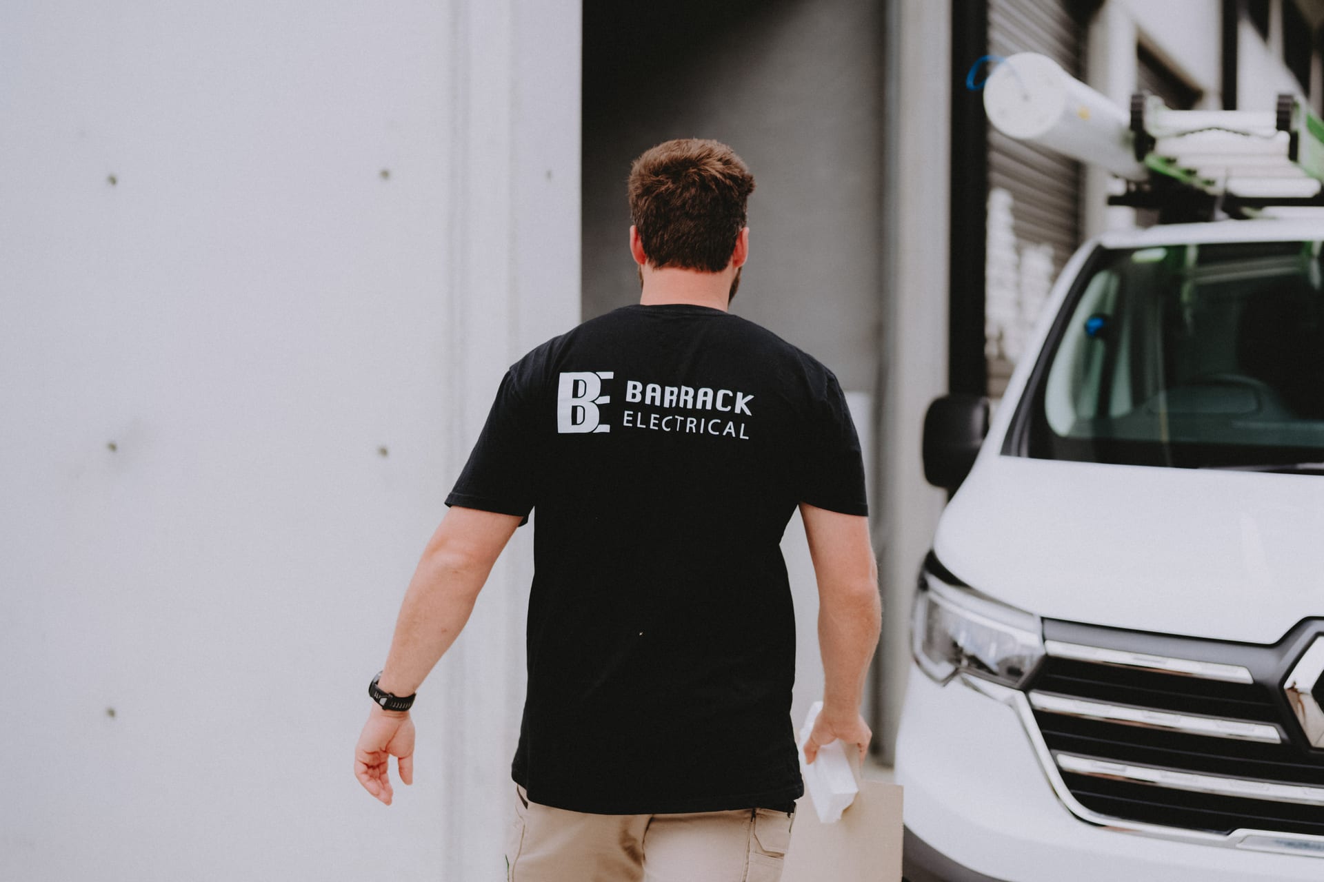 A Barrack Electrical electrician walking back to the work van