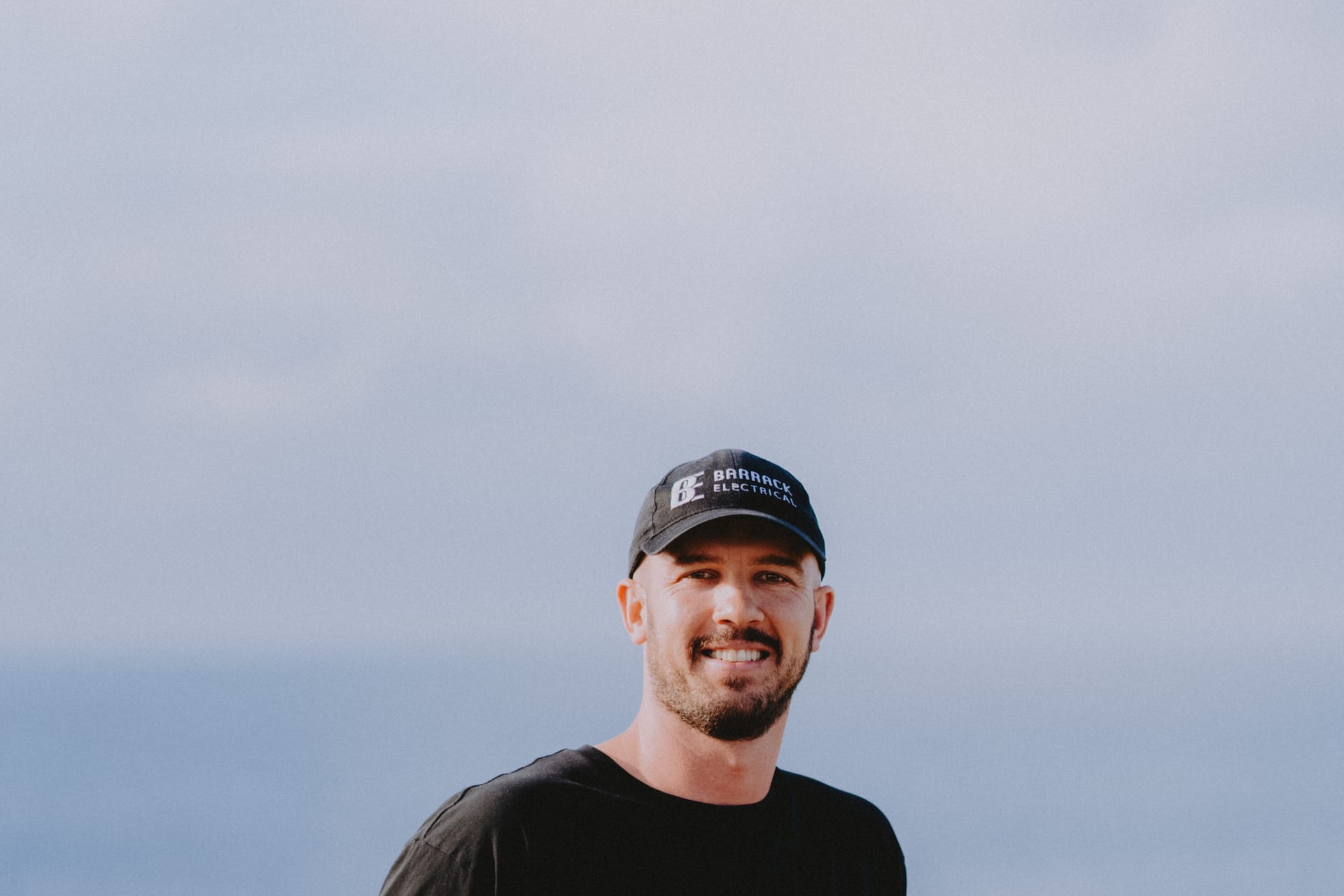 A Barrack Electrical electrician in uniform by the water at Newcastle