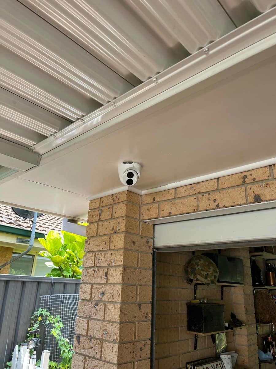 A dome camera mounted on a carport soffit