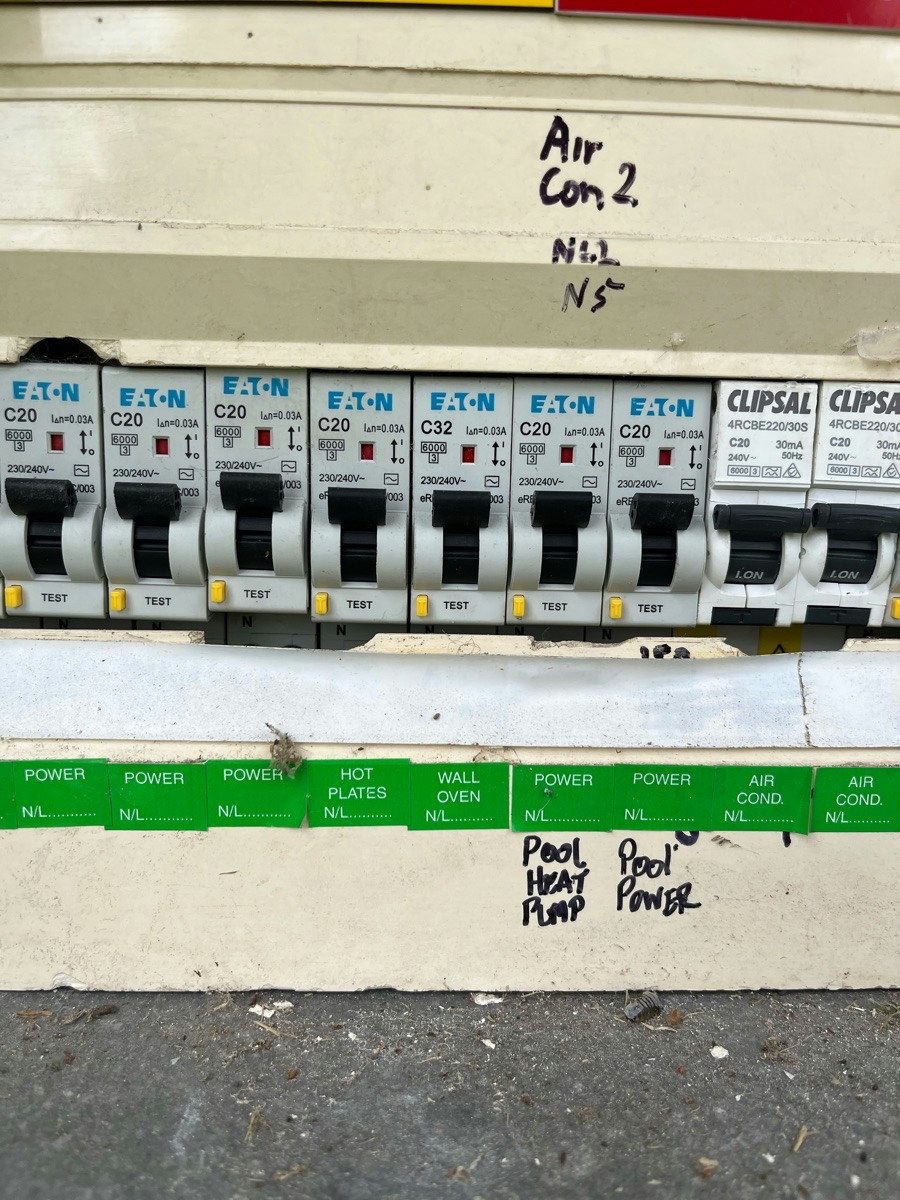 A row of safety switches with the pool heat pump and pool power circuits labelled