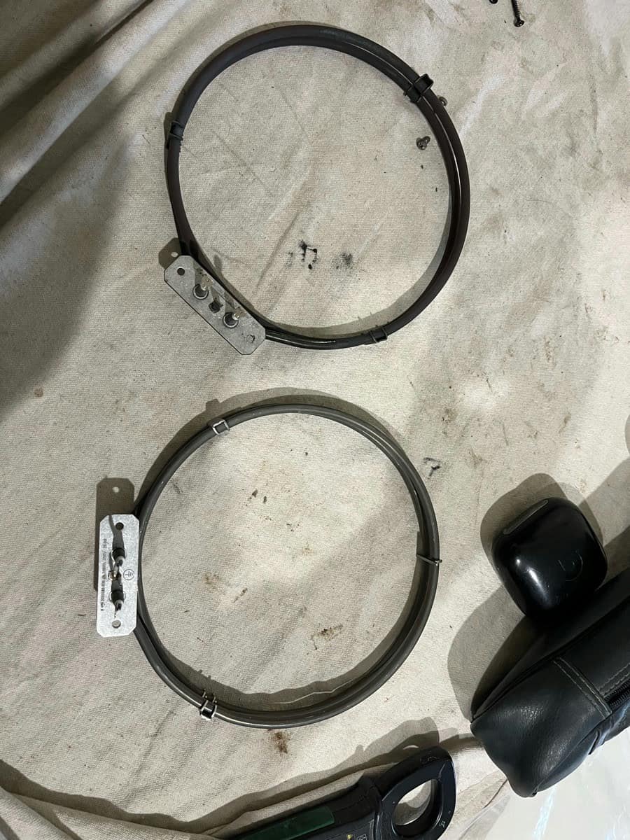 Two fan oven elements laid side by side on a drop sheet