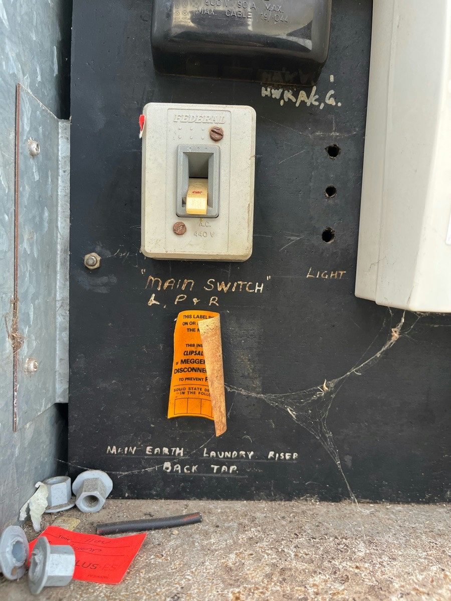 The bakelite main switch on an old switchboard panel before the upgrade