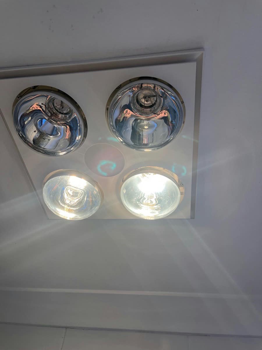 A four lamp bathroom heat unit with two lamps lit