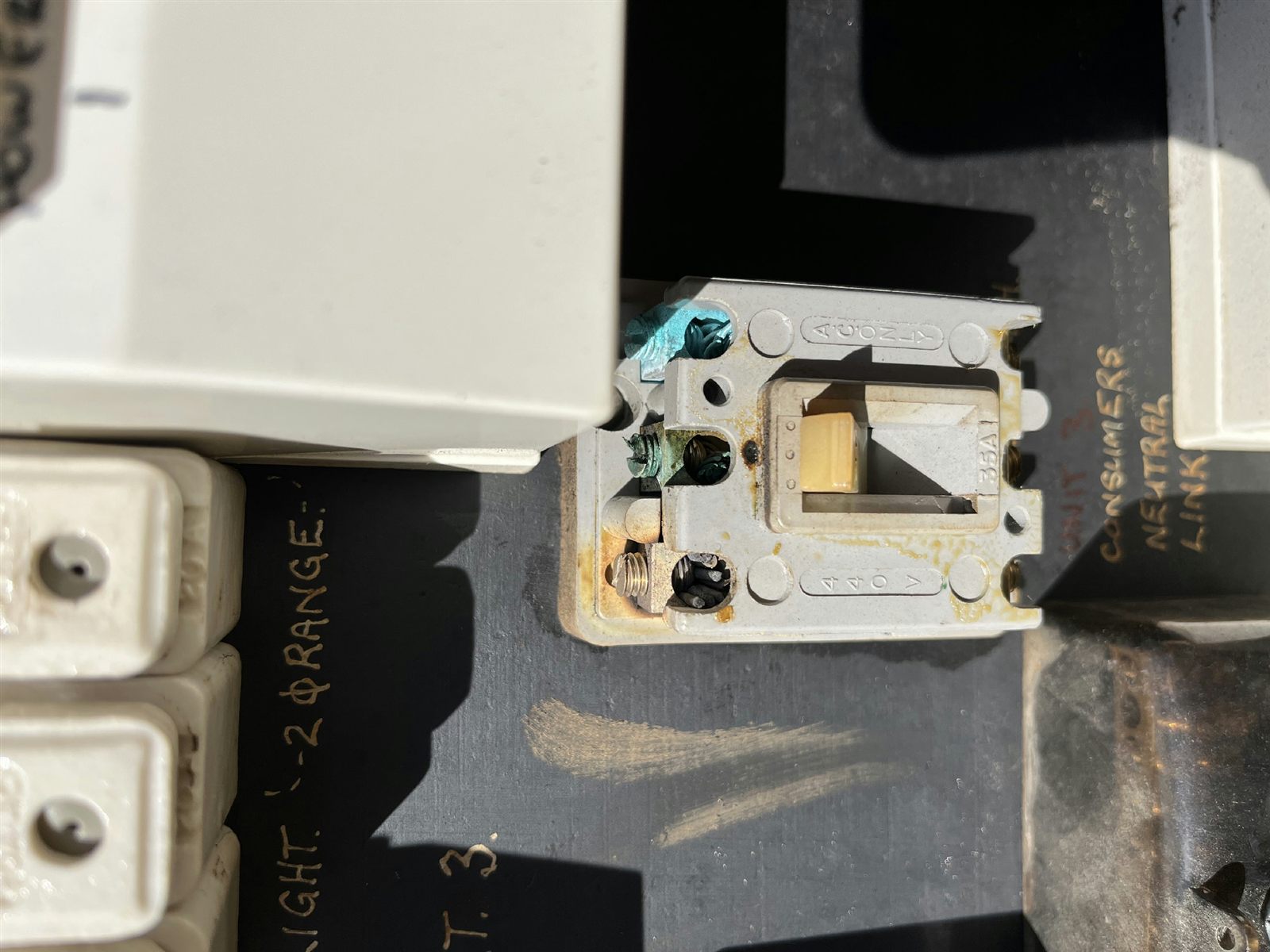 An old switch mechanism removed from a board beside ceramic fuse bodies