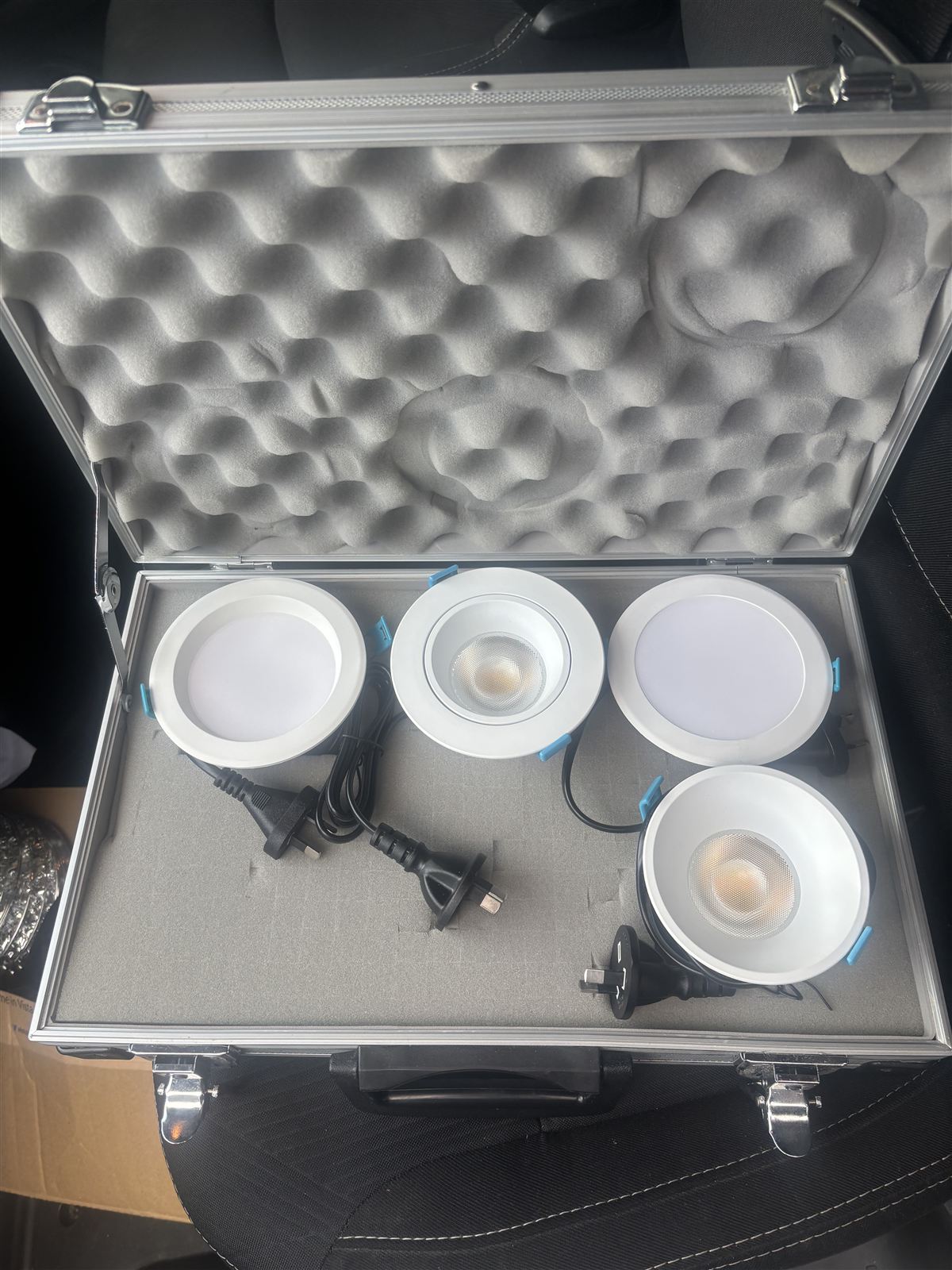 Case of sample LED downlights showing fitting options before replacing old halogens