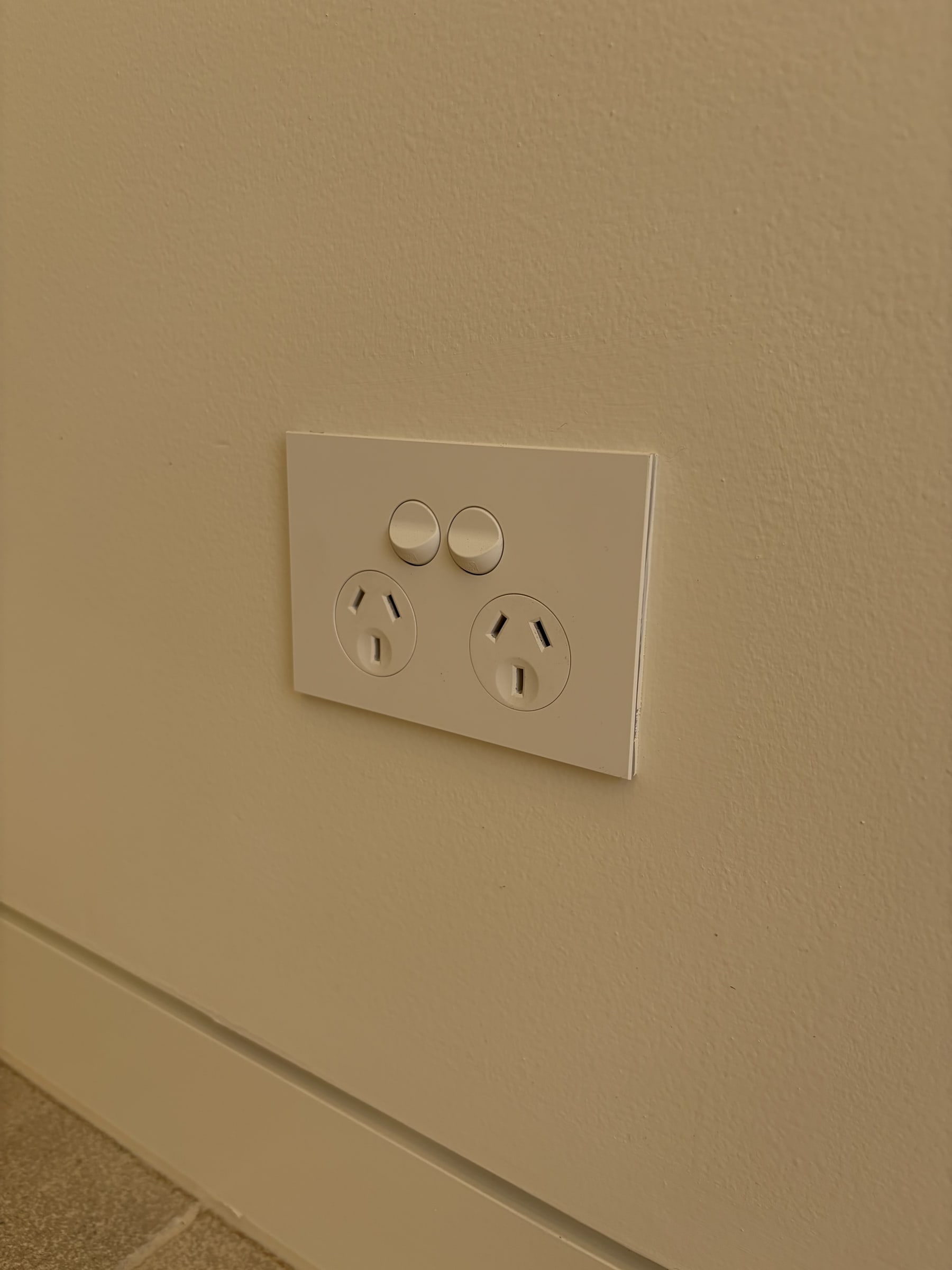 A new double power point fitted to a wall above the skirting board
