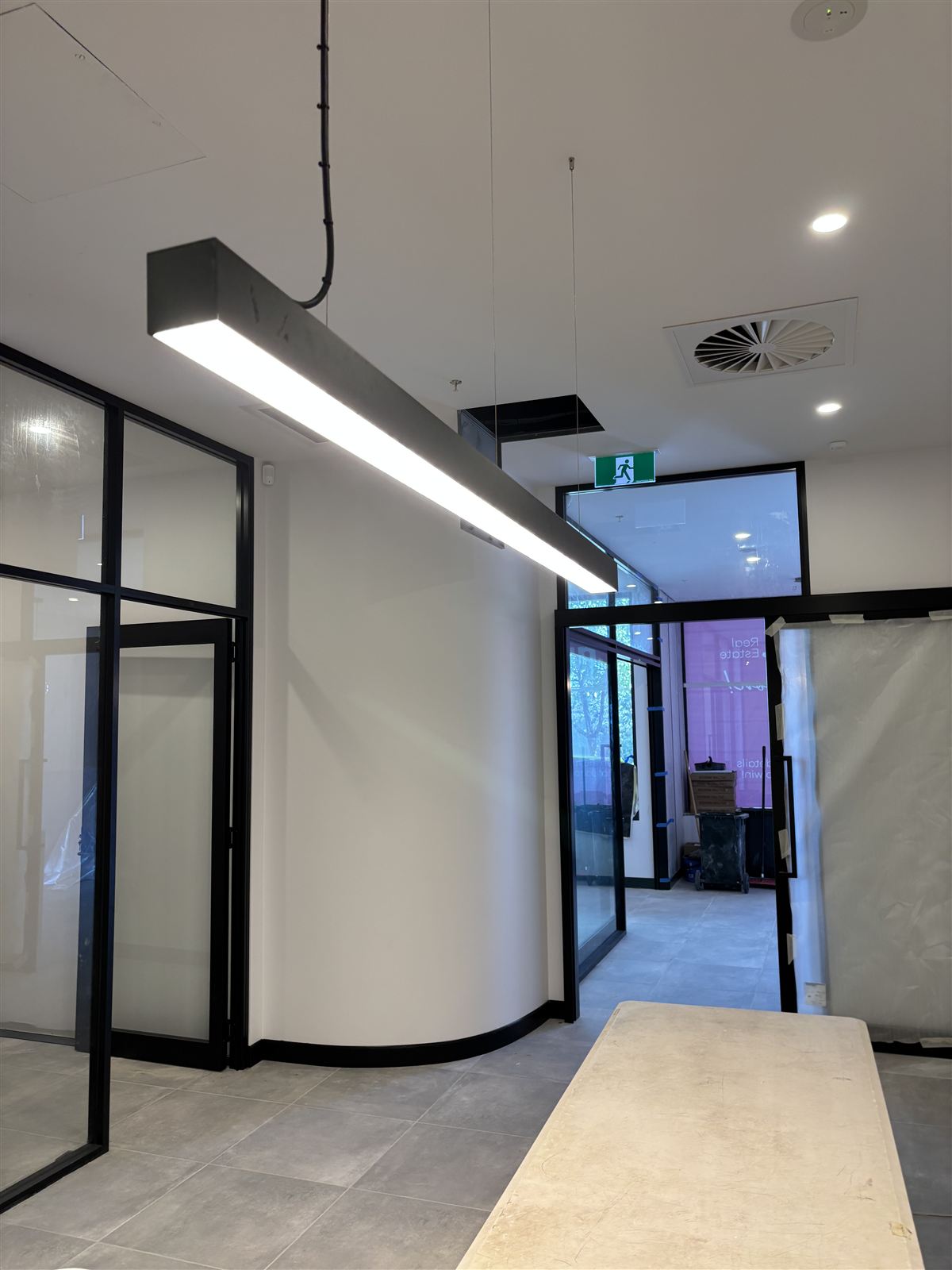 Linear LED pendant and LED downlights lighting an office fit-out