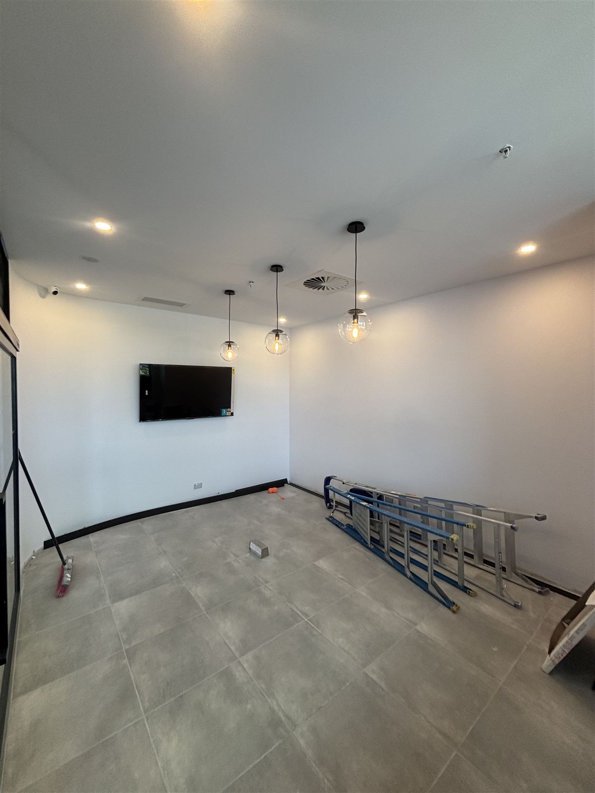 Security camera and pendant lighting in a finished commercial fit-out