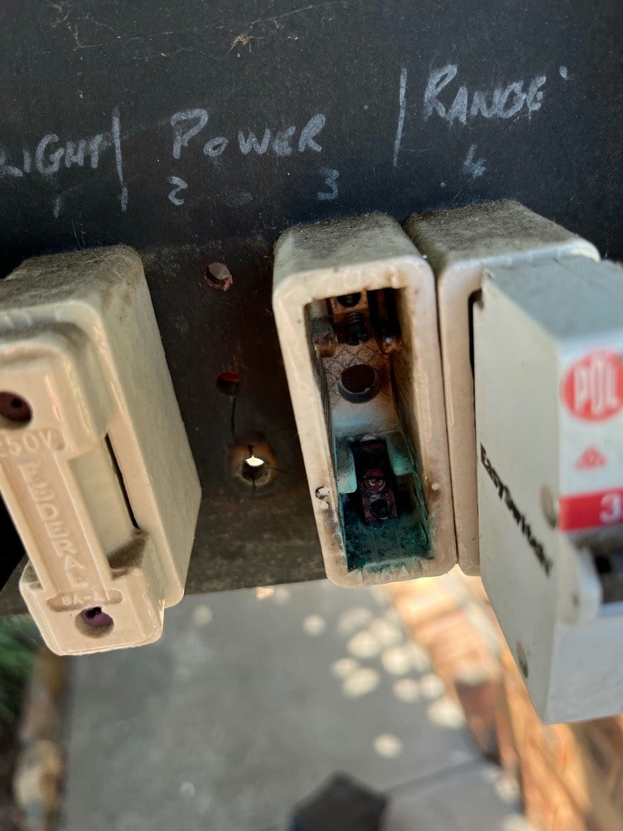 Old ceramic fuse carriers withdrawn from a switchboard, the fuse wire and contacts exposed