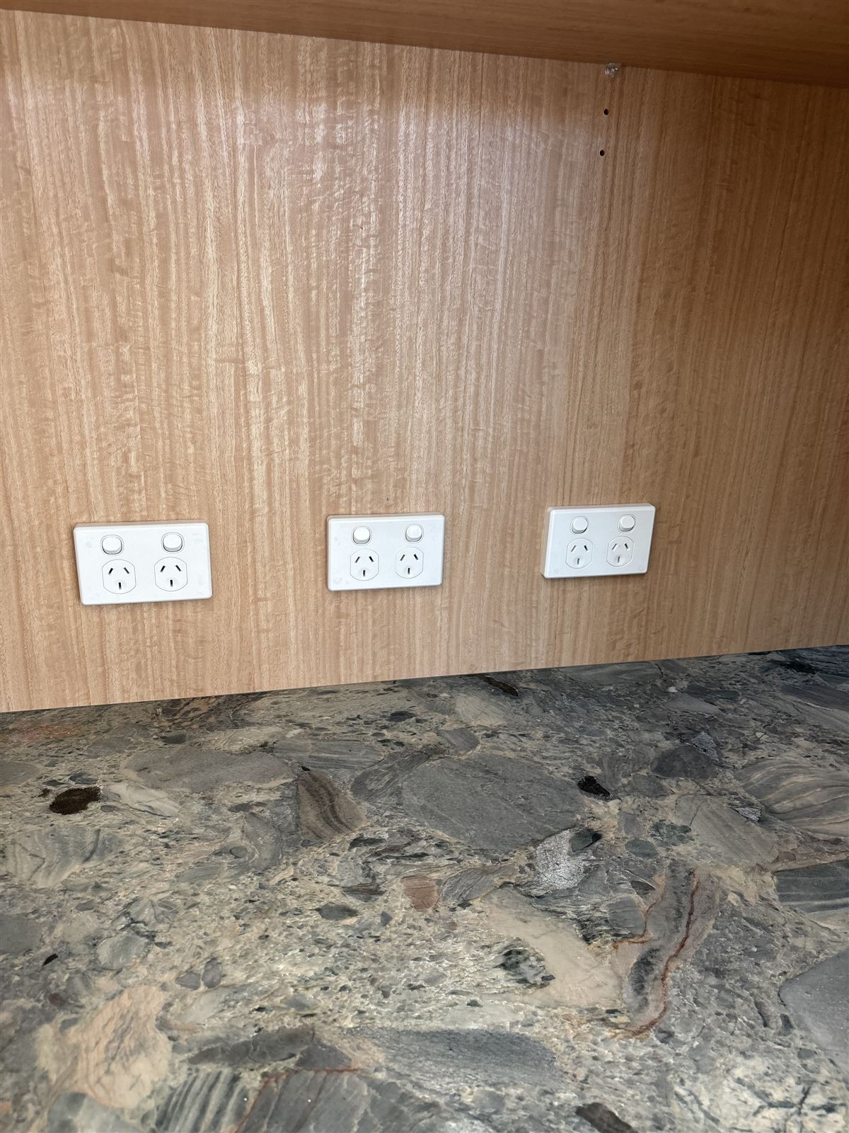 New power points fitted on a timber wall above a benchtop