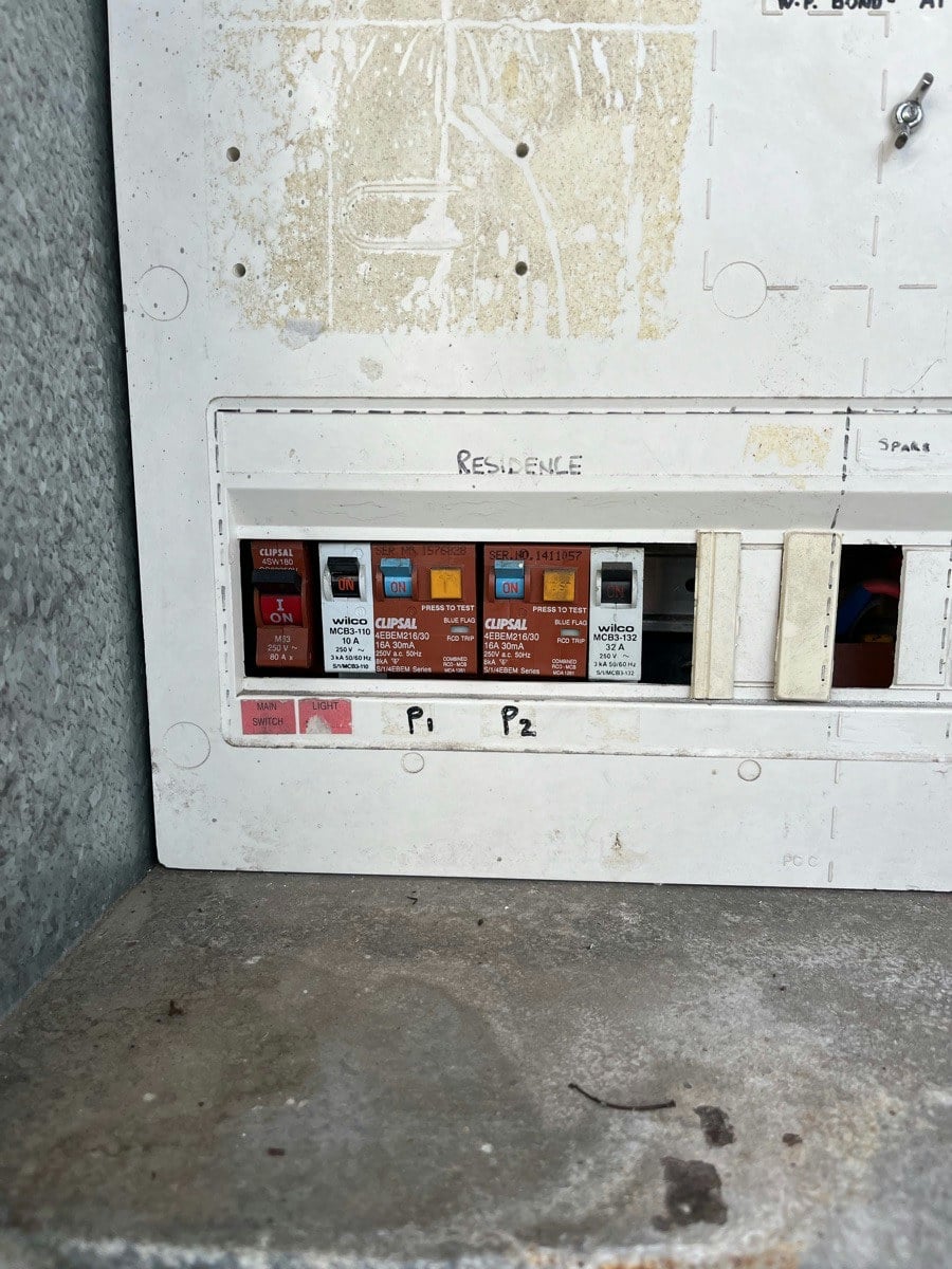 A pair of safety switches in a switchboard, the circuits marked by hand