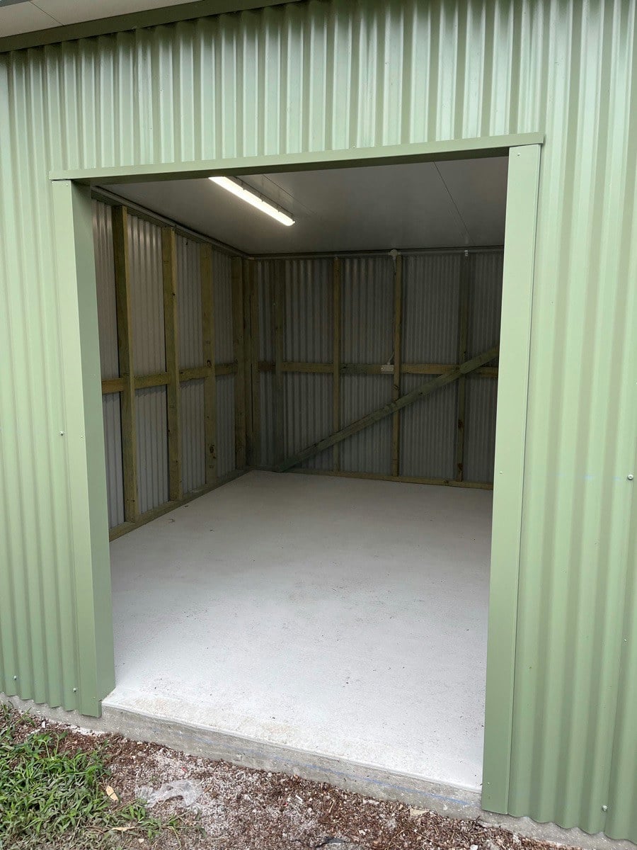 A shed with a new LED batten lit over a bare concrete floor