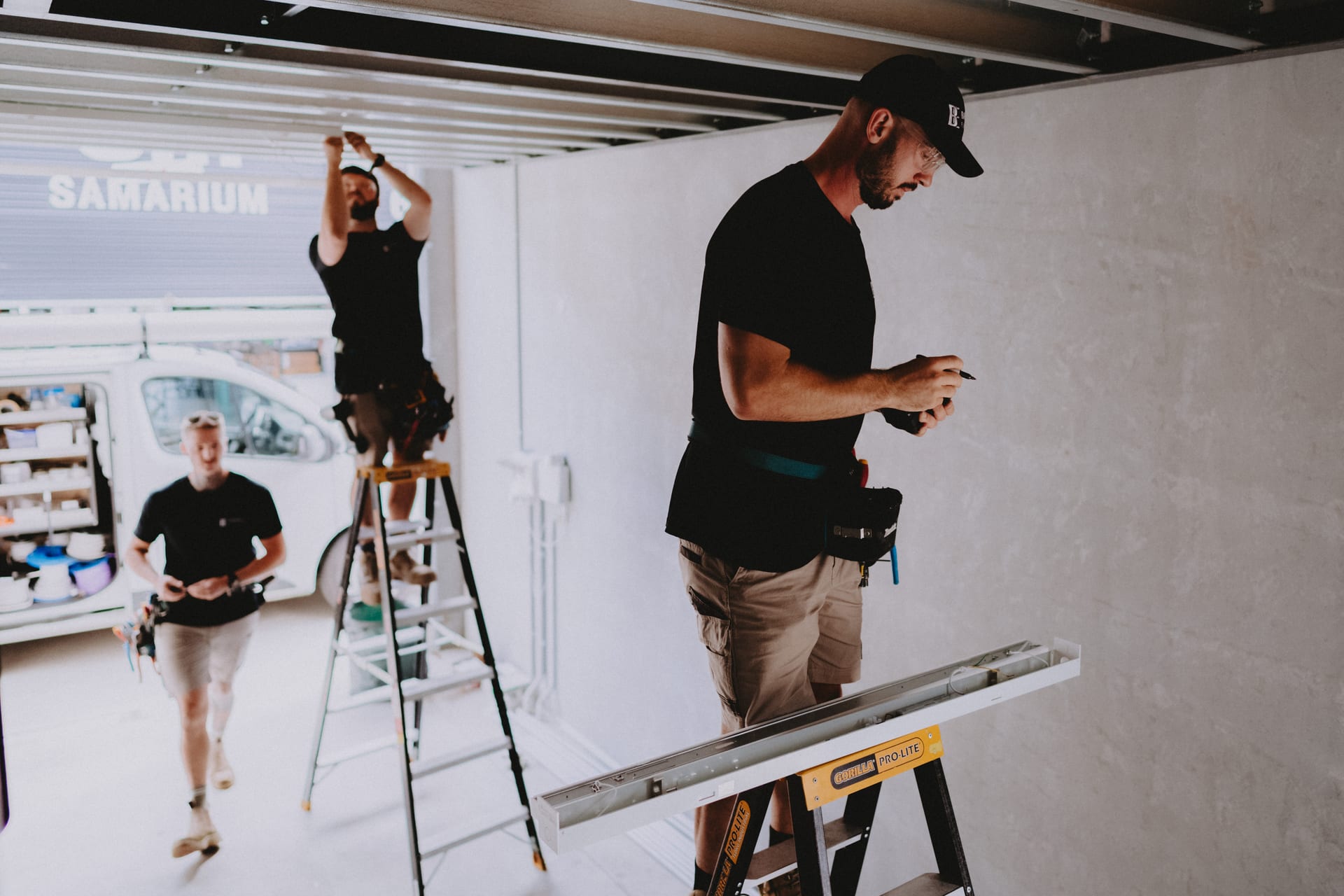 Two Barrack Electrical electricians on a job, one on the ladder and one checking the work in hand