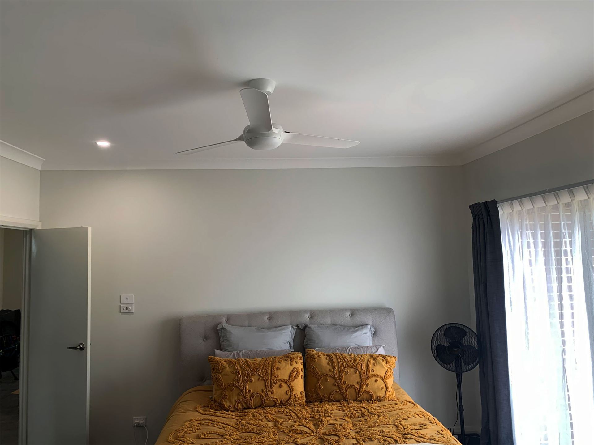 Ceiling fan and LED downlights in a bedroom