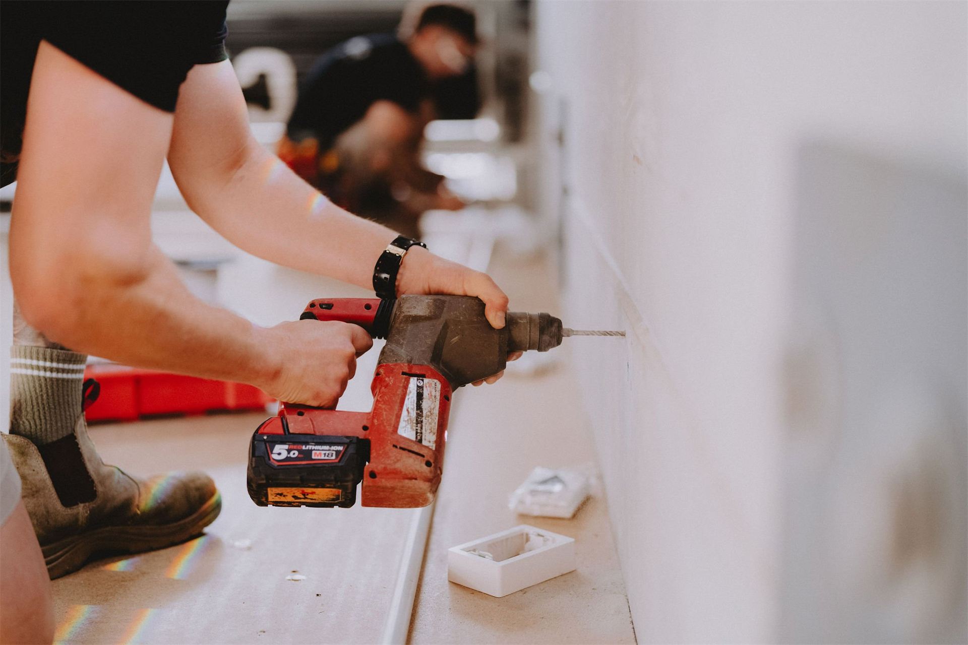 Electrician using a drill on site