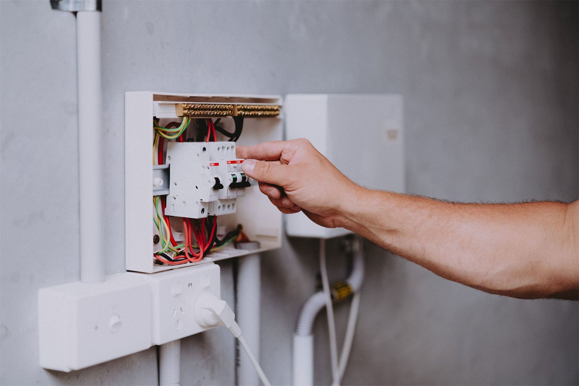 Electrician testing circuits inside a switchboard