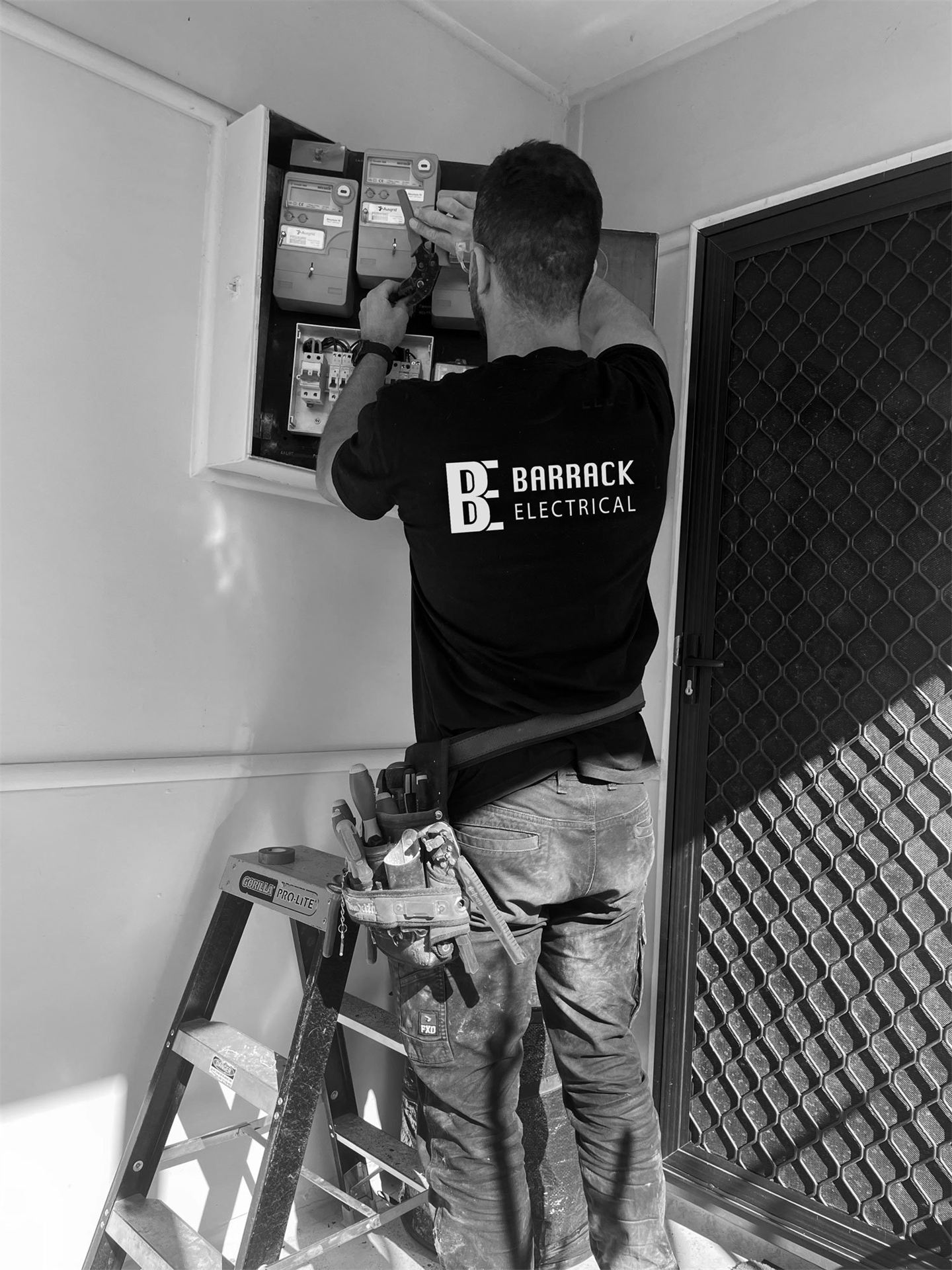 Electrician working on an open switchboard