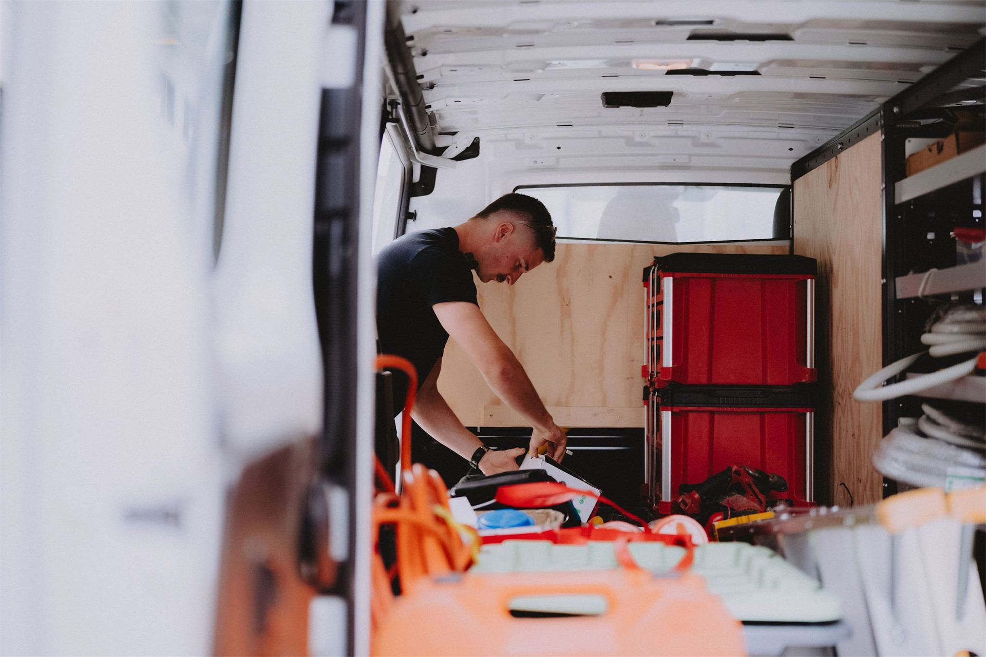 Electrician working from the back of a stocked Barrack Electrical van