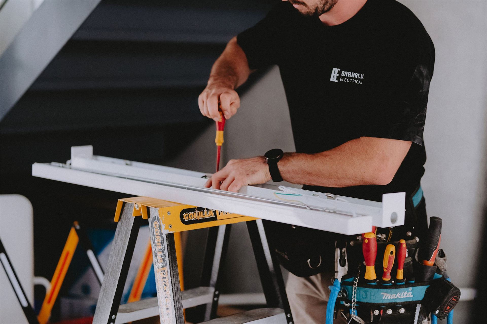 Electrician measuring up on site before a fixed price estimate