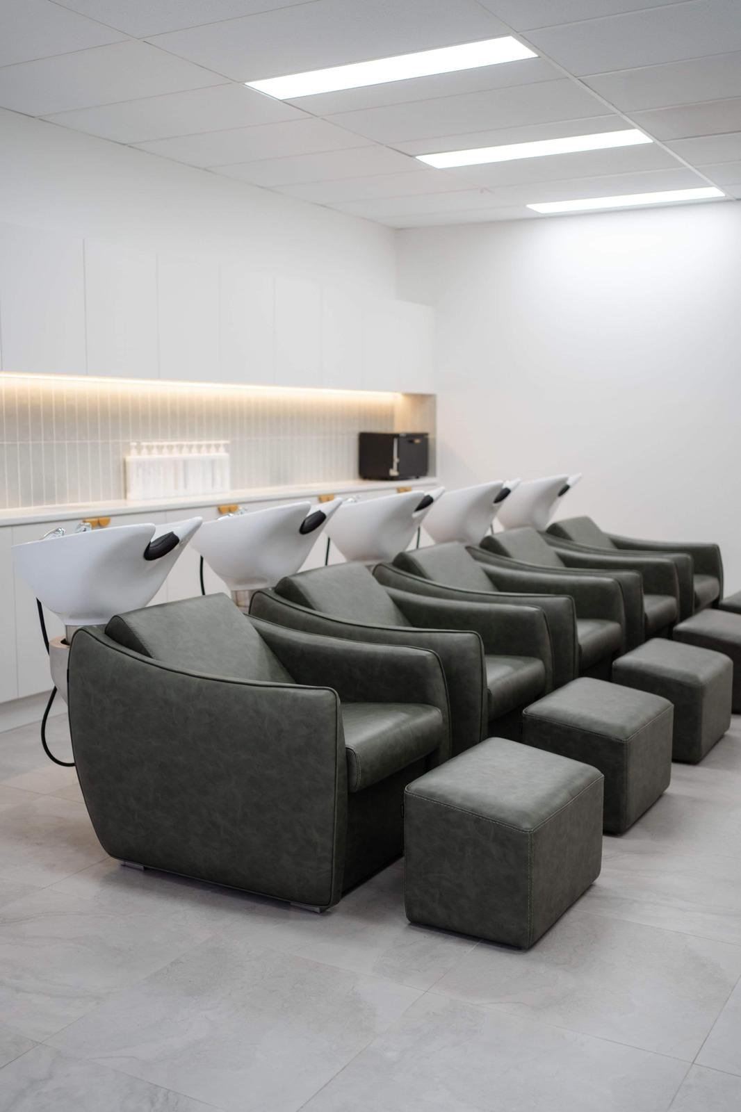 Salon basins under new LED panels and a lit feature wall in a salon fit-out