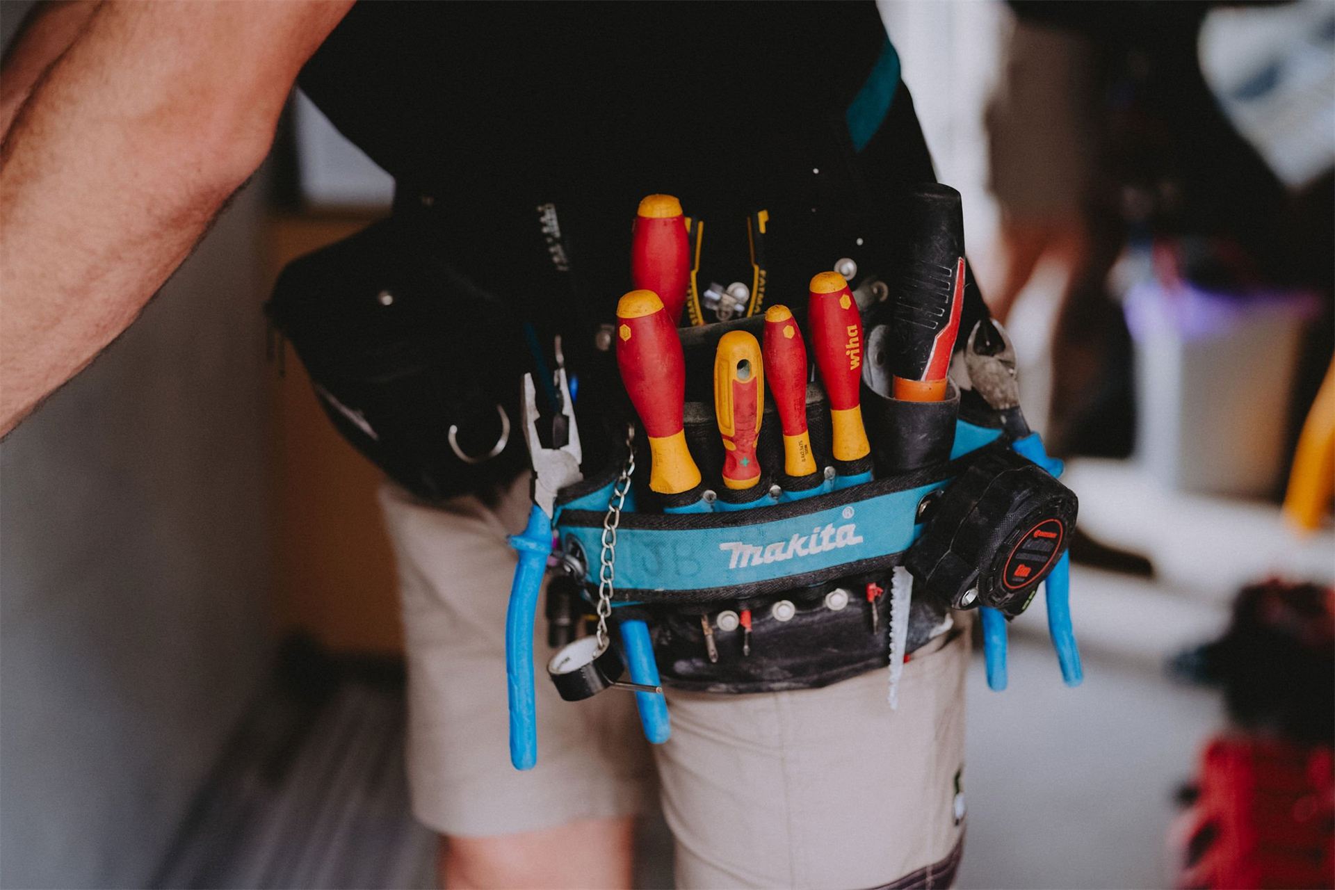 Electrician wearing a tool belt on the job