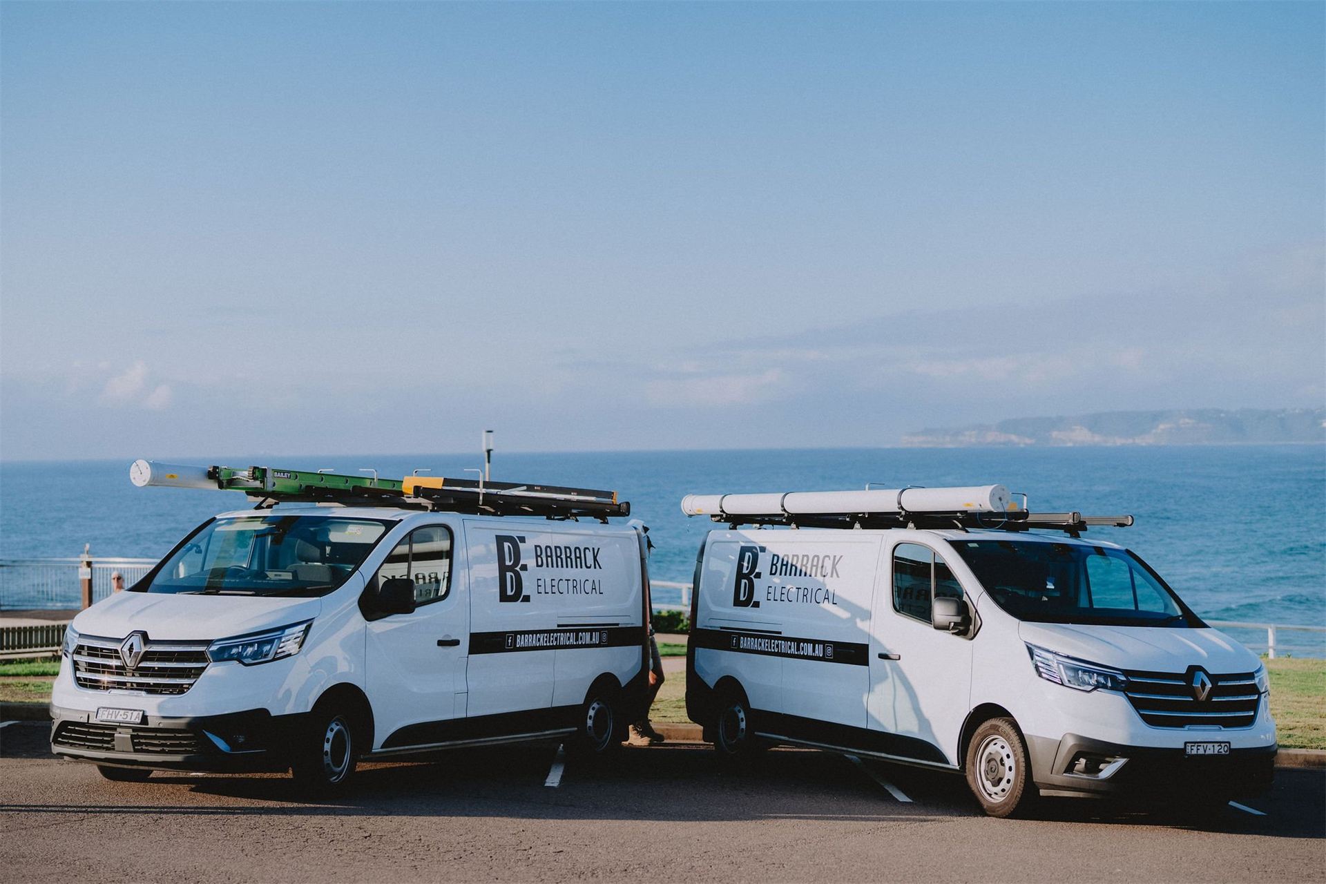 Barrack Electrical work vans parked together by the coast